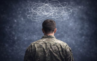 Back view of a uniformed individual with abstract swirling lines above their head representing anxiety, stress, and mental health challenges in first responders and military personnel.