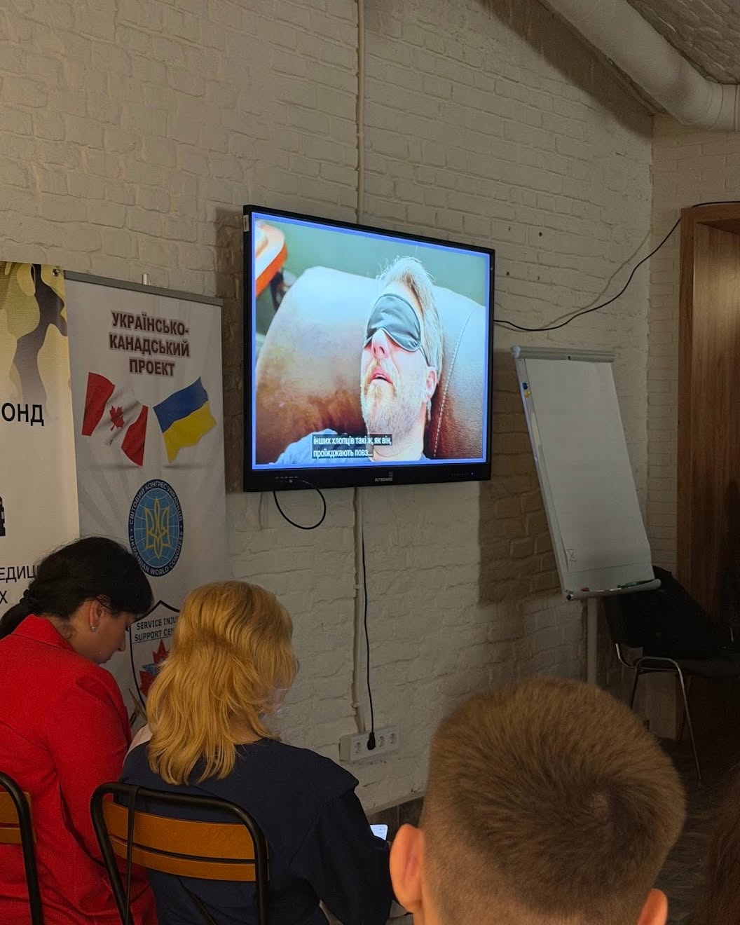 Project Trauma Support Ukraine Presentation Attendees watching a Project Trauma Support presentation in Lviv, Ukraine during a PTSD and moral injury workshop.